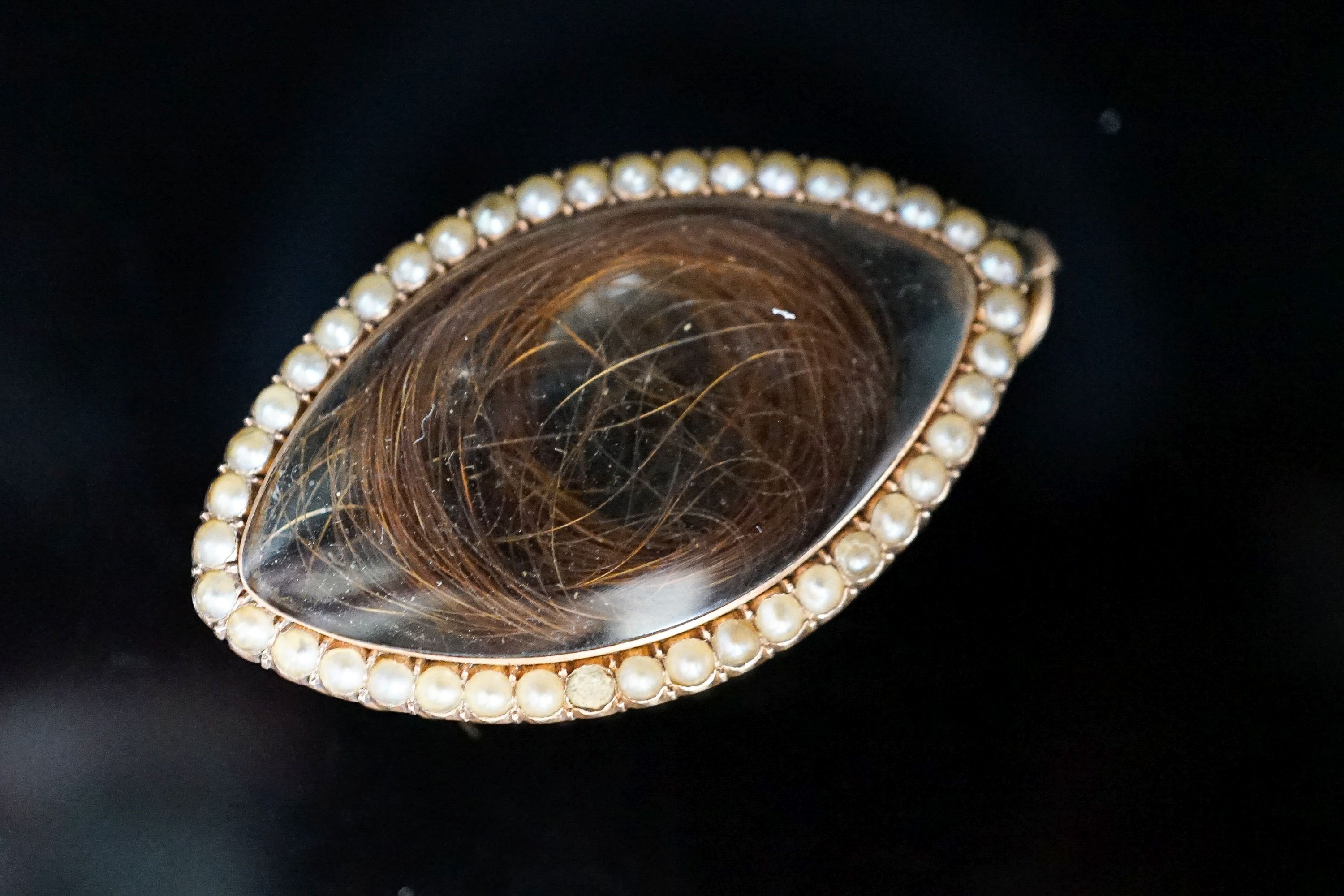 A Regency seed pearl set yellow metal locket and a mother of pearl cameo brooch
